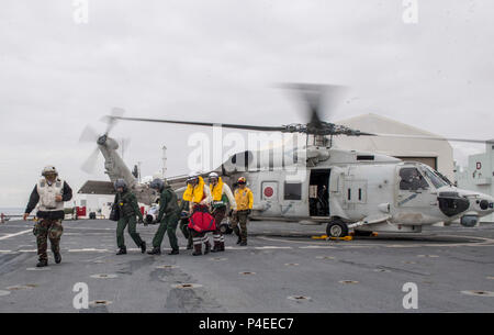 180617-N-RM689-0158  TOKYO, Japan (June 17, 2018) Sailors assigned to Military Sealift Command hospital ship USNS Mercy (T-AH 19) for Pacific Partnership 2018 (PP18) and Japanese Maritime Self-Defense Force (JMSDF) transfer a mock patient from an SH-60K Sea Hawk helicopter attached to the JMSDF during a bilateral medical training team drill between Mercy and JMSDF personnel. USNS Mercy is making port visits to Yokosuka and Tokyo to promote relationships between U.S. Navy Sailors and Japanese citizens through cultural exchange and bilateral training. (U.S. Navy photo by Mass Communication Speci Stock Photo