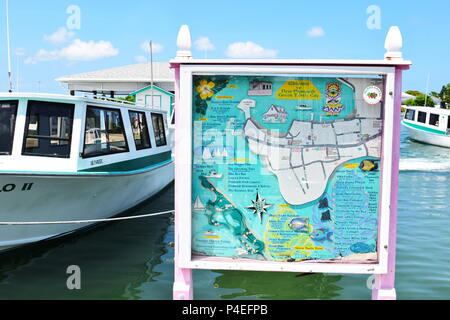 Welcoming sign and map for visitors of Green Turtle Cay at boat dock, the only form on transportation to the island in the Bahamas. Stock Photo