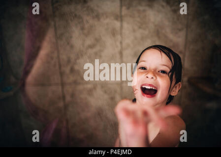 Girl standing in the shower laughing Stock Photo