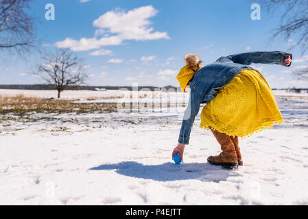 Girl on a Easter egg hunt in the snow Stock Photo