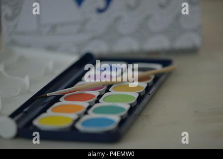 Close-up of watercolour paints and a paintbrush Stock Photo