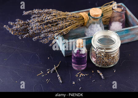 Lavender set - a bouquet of dry lavender, essential oil, cosmetic salt. Spa theme, relaxation and beauty Stock Photo