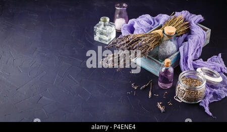 Lavender set - a bouquet of dry lavender, essential oil, cosmetic salt. Spa theme, relaxation and beauty Stock Photo