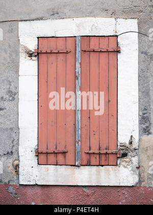 very old reddish brown painted shutters on window in medieval provence house in luberon area Stock Photo