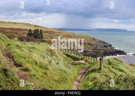 The clifftop view to Dunskey Castle.The ruins of this 16C tower overlook the Irish Sea.from Scotland's coastline.. Stock Photo