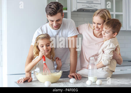 young family cooking breakfast together at kitchen Stock Photo