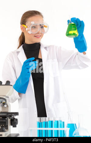 Scientists girl are mixing chemicals or doing some experiment to develop medicine in laboratory. Stock Photo