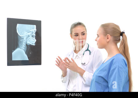 Doctors women discussion and reviewing a resonance magnetic imaging or x ray film checking skull of human head nn examination room. Isolated on white  Stock Photo