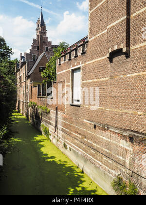 The ' Groen Waterke', a small canal covered in duckweed, next to the houses of refuge of the St Trond's abbey and Tongerlo Abbey in Mechelen, Belgium Stock Photo