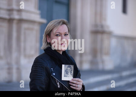 November 17, 2016 - Murcia, Spain: Portrait of Ines Madrigal, a Spanish woman who is pressing charges against Doctor Eduardo Vela for 'kidnapping' in a rare case of prosecution in the country's stolen babies scandal. She is posing with a photo of her adoptive mother, Ines Perez. Ines Madrigal was born on the 4th of June 1969 to an unknown woman in the San Jamon clinic in Madrid. She was then 'offered' by Dr Vela as a gift to Ines Perez, a woman who could not bear children. The trial is set to take place in early 2017 after Ines Madrigal provided evidences and testimonies from Ines Perez, her a Stock Photo