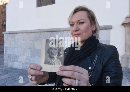 November 17, 2016 - Murcia, Spain: Portrait of Ines Madrigal, a Spanish woman who is pressing charges against Doctor Eduardo Vela for 'kidnapping' in a rare case of prosecution in the country's stolen babies scandal. She is posing with a photo of her adoptive mother, Ines Perez. Ines Madrigal was born on the 4th of June 1969 to an unknown woman in the San Jamon clinic in Madrid. She was then 'offered' by Dr Vela as a gift to Ines Perez, a woman who could not bear children. The trial is set to take place in early 2017 after Ines Madrigal provided evidences and testimonies from Ines Perez, her a Stock Photo