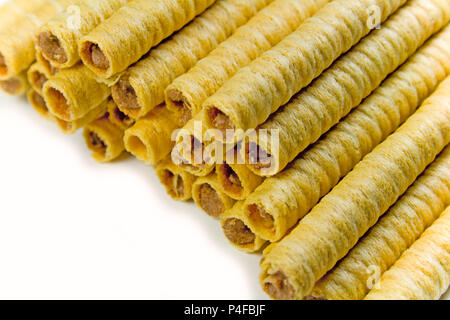 heap of striped wafer tubules with chocolate cream closeup Stock Photo