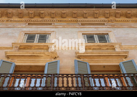 Old Façade of an residential building with windows and shutter in the Italian city of Verona Stock Photo
