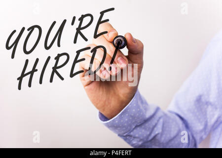 Writing note showing  You Are Hired Motivational Call. Business photo showcasing New employee recruited Worker selected Stock Photo