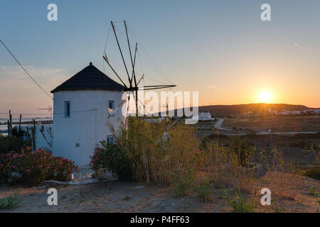 Traditional cycladic windmill at sunset on Paros island, Cyclades, Greece Stock Photo