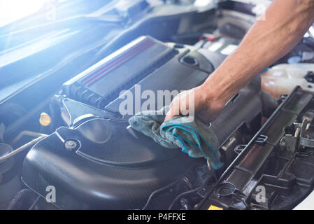 Mechanic cleaning car engine Stock Photo
