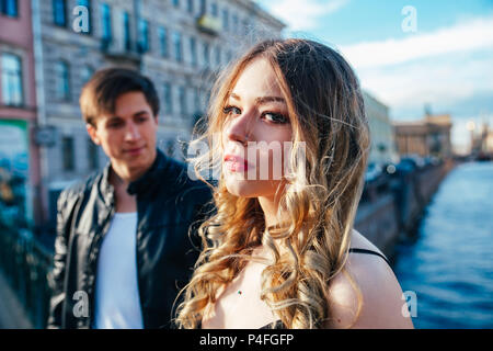Happy young couple is spending vacation holidays in St. Petersburg. Both look really happy. They are strolling along the streets of the old town Stock Photo