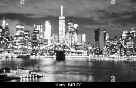 Blurred black and white picture of the New York cityscape at night, urban abstract background, USA.