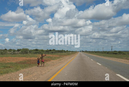 two young African children selling nuts on the side of the road in rural Northern Cape, South Africa concept child employment in poor communities Stock Photo