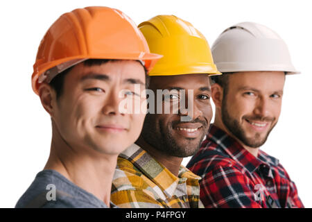 group of multiethnic construction workers in row looking at camera Stock Photo