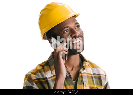 smiling african-american construction worker talking by phone isolated on white Stock Photo