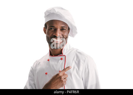 handsome african american chef pointing away isolated on white Stock Photo