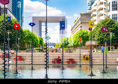'Le Bassin de Takis' by Greek artist Takis is a colourful piece of art integrated into a water feature at La Defense in Paris, France Stock Photo