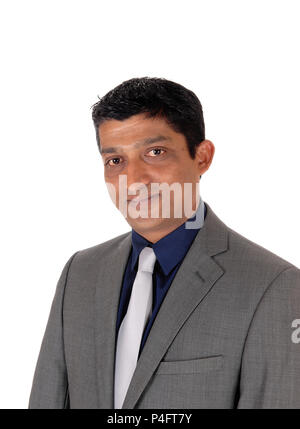 A close up image of the portrait of a east Indian business man in a gray suit and silver tie, isolated for white background Stock Photo