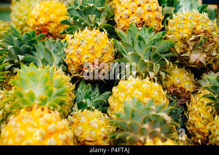 Small pineapples for sale in a market Stock Photo