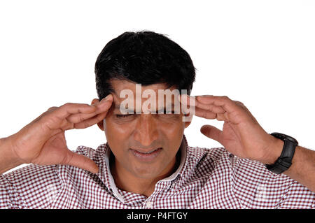 A closeup image of an East Indian man with very heavy headache closing his eyes and rubbing his head, isolated for white background Stock Photo