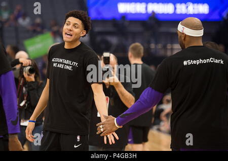 Sacramento, California, USA. 25th Mar, 2018. Sacramento Kings forward Justin Jackson (25) slaps hands with Sacramento Kings guard Vince Carter (15) as they wear t-shirts bearing the name of Stephon Clark during a game at Golden 1 Center on Sunday March 25, 2018 in Sacramento, Calif. The Kings and Celtics wear shirts bearing the name of the unarmed man, Stephon Clark, who was killed by Sacramento police. The black warm-up shirts have 'Accountability. We are One' on the front and 'Stephon Clark' on the back. Credit: Paul Kitagaki Jr./Sacramento Bee/ZUMA Wire/Alamy Live News Stock Photo