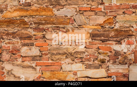 Old composite wall with stone blocks and bricks as background Stock Photo