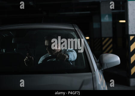 undercover male agent doing surveillance and using talkie walkie in car  Stock Photo - Alamy