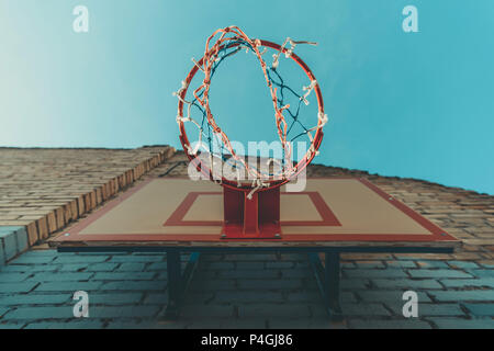 bottom view of basketball hoop on wall with graffiti Stock Photo