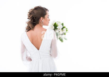 back view of bride in white dress holding wedding bouquet, isolated on white Stock Photo