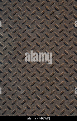 Closeup of distressed, mottled, grungy industrial checker plate rusty metal background texture with diamond pattern wallpaper for construction, heavy  Stock Photo