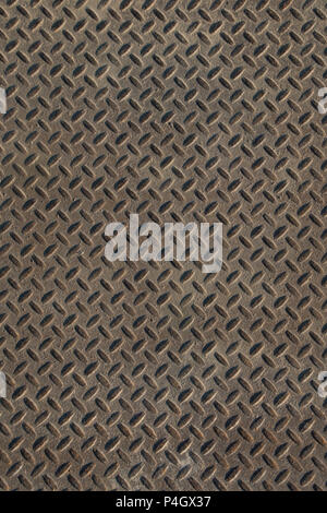 Closeup of distressed, mottled, grungy industrial checker plate rusty metal background texture with diamond pattern wallpaper for construction, heavy  Stock Photo