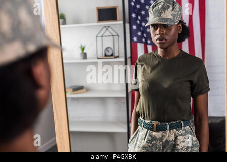 African american female soldier posing by the mirror Stock Photo - Alamy