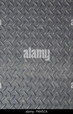 Closeup of a distressed, mottled, gungy industrial diamondplate, chequerplate rusty metal background texture with diamond grip pattern perfect for wal Stock Photo