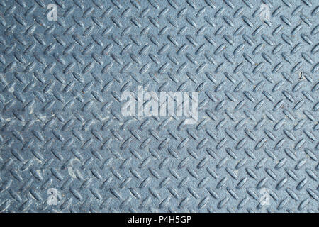 Closeup of a distressed, mottled, gungy industrial diamondplate, chequerplate rusty metal background texture with diamond grip pattern perfect for wal Stock Photo