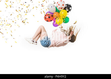 girl with colorful balloons and shiny confetti falling isolated on white Stock Photo