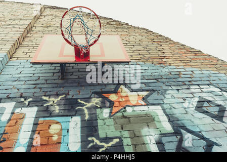 bottom view of basketball hoop on wall with colorful graffiti Stock Photo