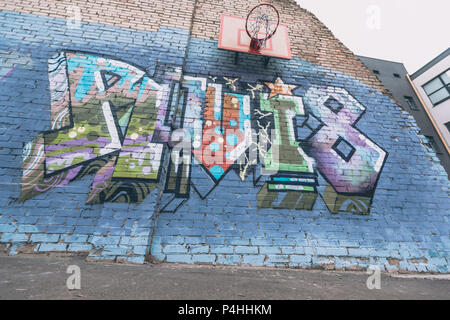 colorful graffiti on wall with basketball hoop Stock Photo