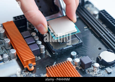 Installing the processor in the motherboard socket. Close up Stock Photo