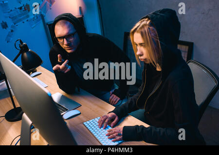confident couple of hackers working on malware together Stock Photo