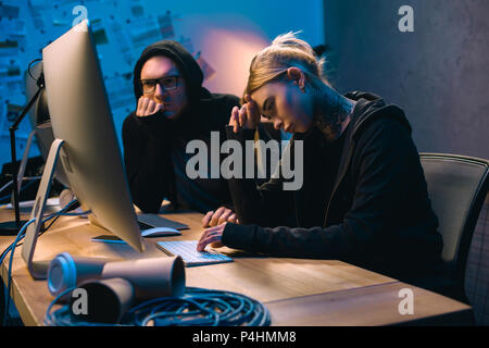 depressed couple of hackers having problem with malware development Stock Photo