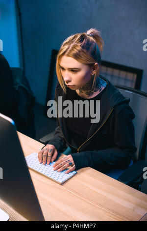 high angle view of serious young female hacker developing malware Stock Photo