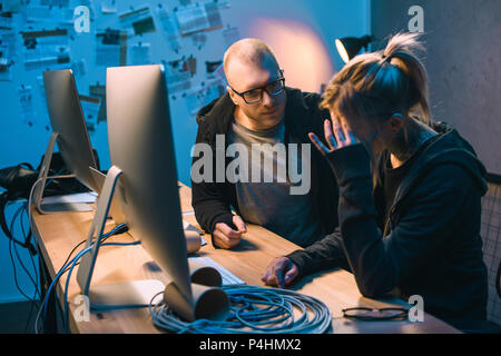 depressed couple of hackers have problem with malware development Stock Photo