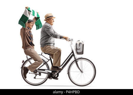 Elderly soccer fans riding a bicycle isolated on white background Stock Photo