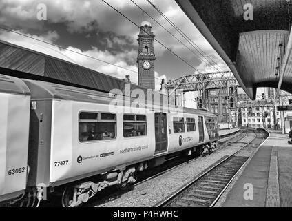 Mono image of Delayed Electric Northern Railway EMU train at Manchester Oxford Road Railway station, North West England, UK, back to the 1970s Stock Photo